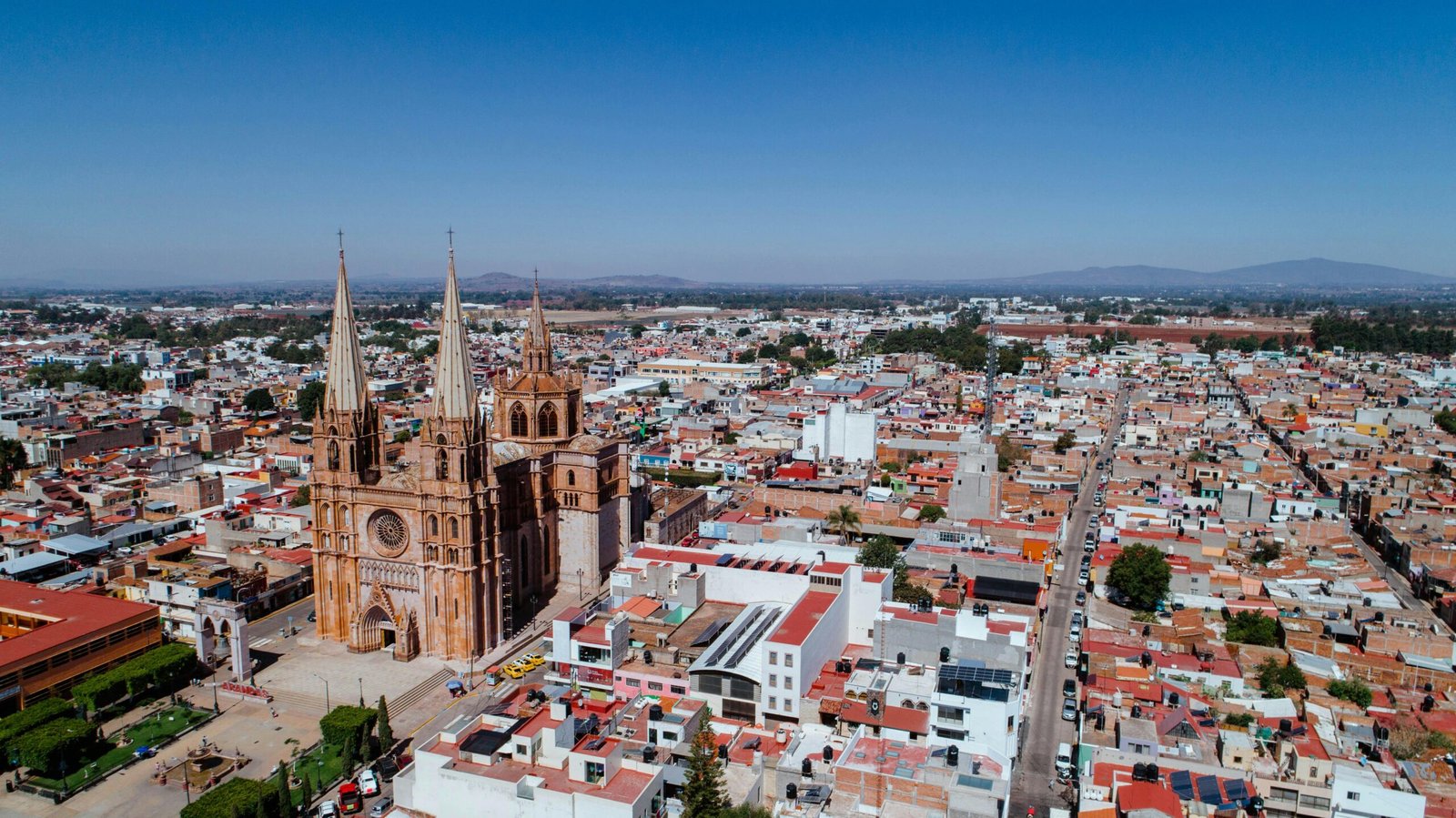 Aerial view of the Gothic cathedral in Tequila, Mexico, surrounded by urban landscape.